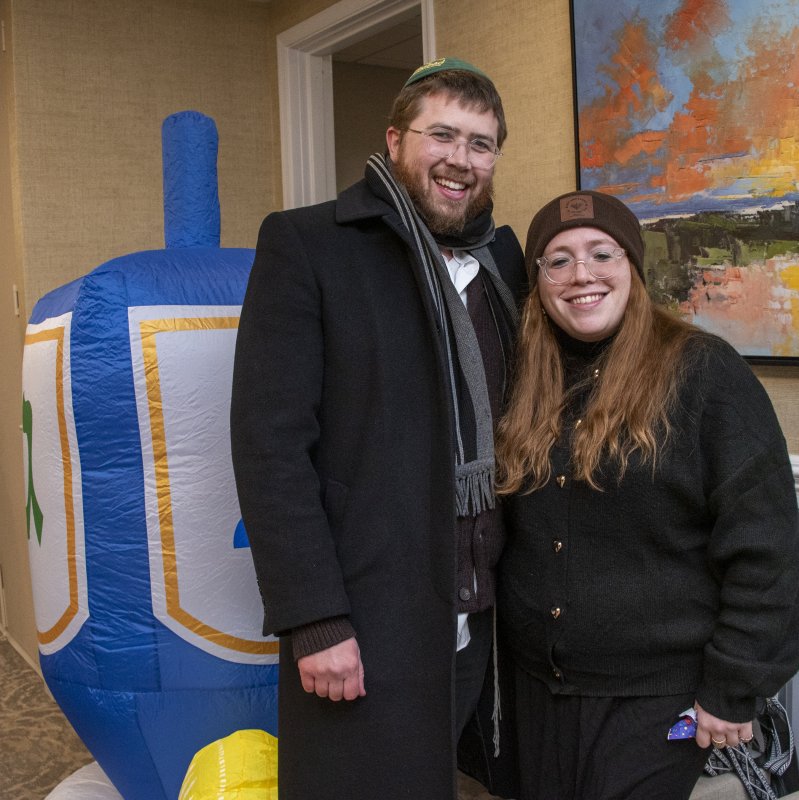 Rabbi Sholom Vogel and Rebbetzin Chanale Vogel pause for a photo near the big dreidel.